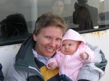 Audrey riding the boat with Grandma.  The people on the other side of the glass look really enthused, too.