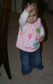 Although it looks like she bumped her head, she's really just trying to remove her clip.