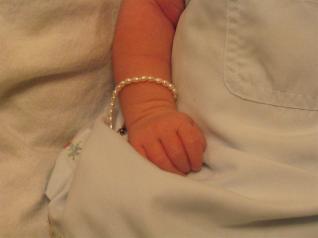 This is Audrey with her bling bling.  I bought this for her before we even had positive ultrasound pictures...  just a hunch that she was a she.  It's a little big still.  Fits better around her forearm.