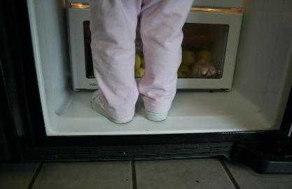 Audrey is climbing all over the place (she even walks up stair now!) and figured out she could get into the contents of the fridge by simply climbing in!
