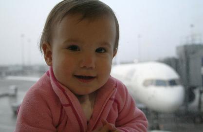 Getting ready to leave on her 18th plane flight.  She's so excited!  Although, the plane in the background wasn't ours.  I wish it was, though, that one was going to Hawaii.